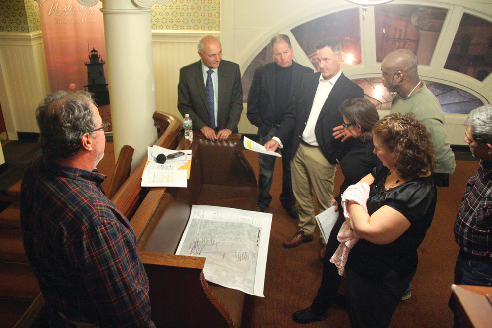 HALLWAY REVIEW: Ralph Palumbo (at left rear) of Southern Sky Renewables meets with neighbors to the proposed solar park on West Shore Road prior to Monday&rsquo;s council meeting.