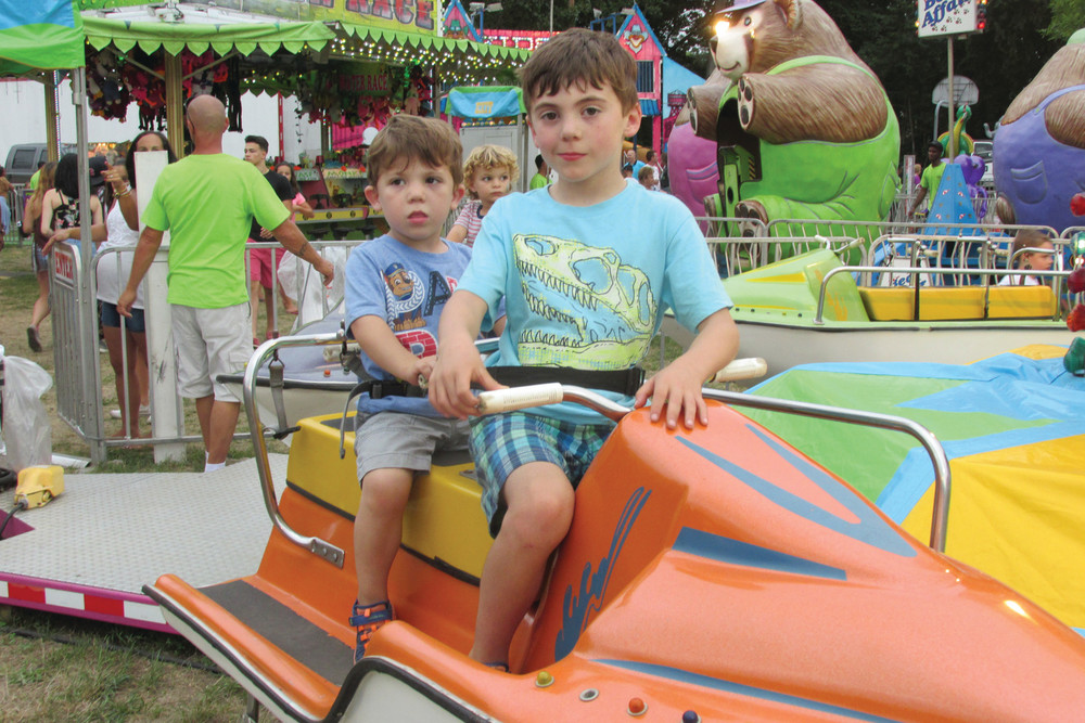 TAKING A RIDE: The on-land boat rides were fun for youngsters like Lucca and Lorenzo Chionchio Sunday afternoon in Johnston.