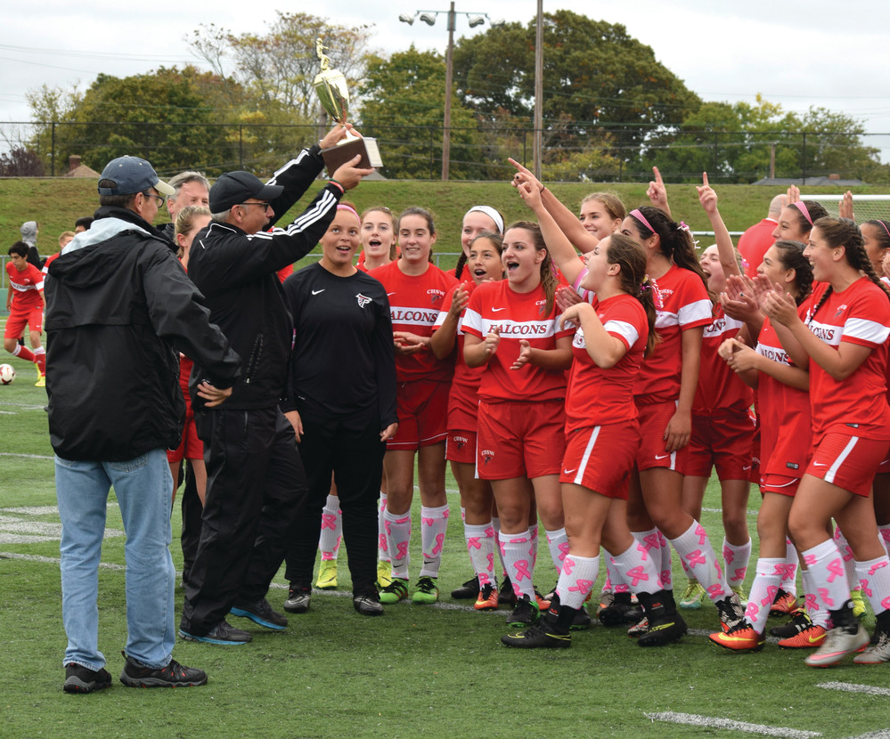 WESTWARD BOUND: The West girls' team celebrates as Head Coach Jeremy Sherer raises the trophy.