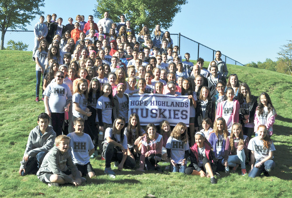 HOPE HIGHLANDS HUSKIES: The seventh-grade students took time out to pose with Principal Alex Kanelos at the walkathon, displaying the banner that highlights the Husky name.
