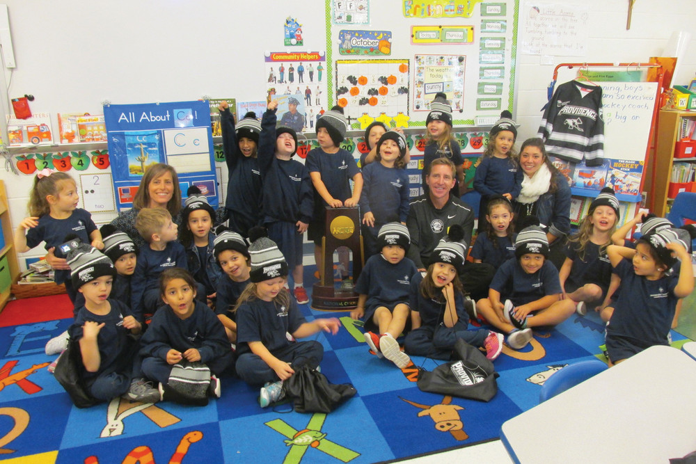 TROPHY TROUPE: Members of Nicole Whittaker&rsquo;s Immaculate Conception pre-K class surrounded PC head hockey coach Nate Leaman, who brought along the Friars&rsquo; national championship trophy. His visit was arranged by parent Steve Napolillo, who doubles as the college&rsquo;s senior associate athletic director.