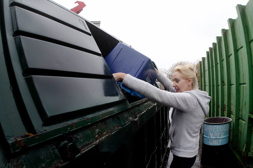 Karen Sousa dumps her recyclables at the transfer station Tuesday afternoon. The recycling bins in the center of the lot near the entrance are scheduled to be removed by the end of the month and replaced by single-stream recycling inside the transfer station building.