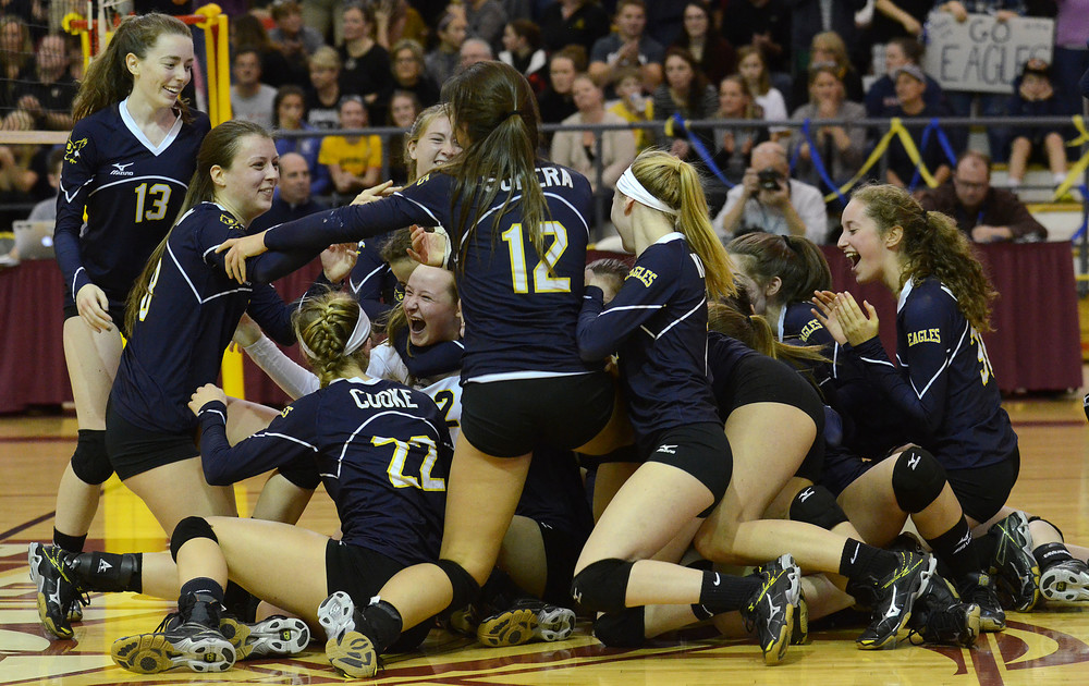 The Lady Eagles celebrate after winning the girls volleyball Division I State Championship by defeating North Kingstown in three games at RIC on Saturday afternoon.