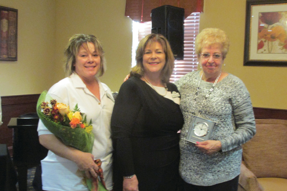 SPECIAL GIFTS: Maryann Grace (left) surprised Rhonda Simmons (left) and Elaine Morin (right) with special awards Sunday in recognition of their extraordinary work in the housekeeping department at The Bridge at Cherry Hill.