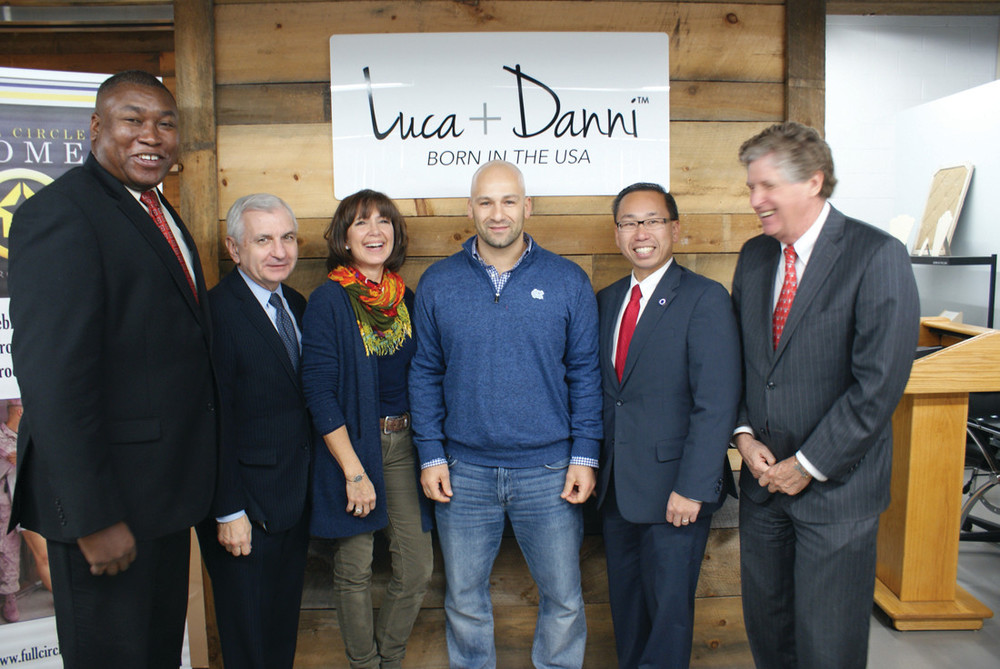 AT LUCA + DANNI: Participating in the gift wrapping of bracelets designed and furnished by Luca + Danni, which will go to loved ones of service people, are Director of Veterans Affairs Kasim Yarn, Senator Jack Reed, Full Circle Home Executive Director Vickie Durfee, Owner and CEO of Luca + Danni, Fred Magnanimi, Mayor Allan Fung and Lt. Governor Dan McKee.