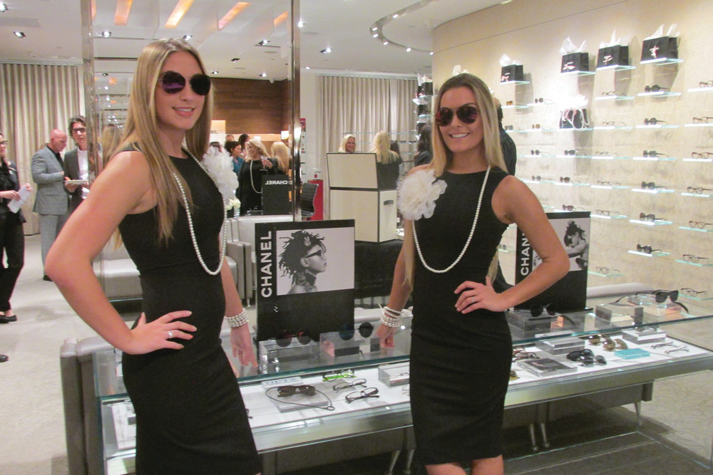 CLASSIC CHANEL: Models Leah Skinner, left, and Livia Stencel, who is also an executive assistant at OPTX RI, show off the new Chanel Prestige Collection eyeglasses during last Friday night&rsquo;s trunk show in Johnston.