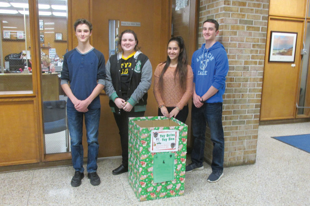 TOY TREK: The brothers Savard, Ryan and Joshua, are joined by fellow Johnston Police Explorers Heather Best and Abby Heiser at this decorated box, one of the many Post 405 hopes to fill during their annual &ldquo;Toys for Kids&rdquo; Drive that will continue through Dec. 13.