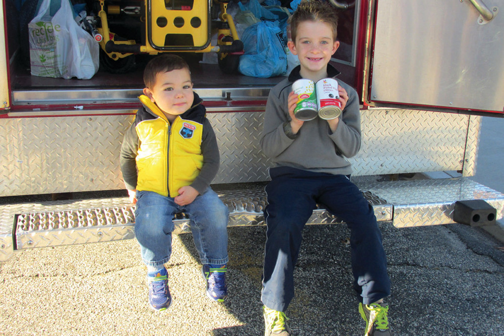 TINY TANDEM: The brothers Brophy -- Brennan (left) and Brody -- added to last Saturday&rsquo;s food collection during Fire Bowl III.