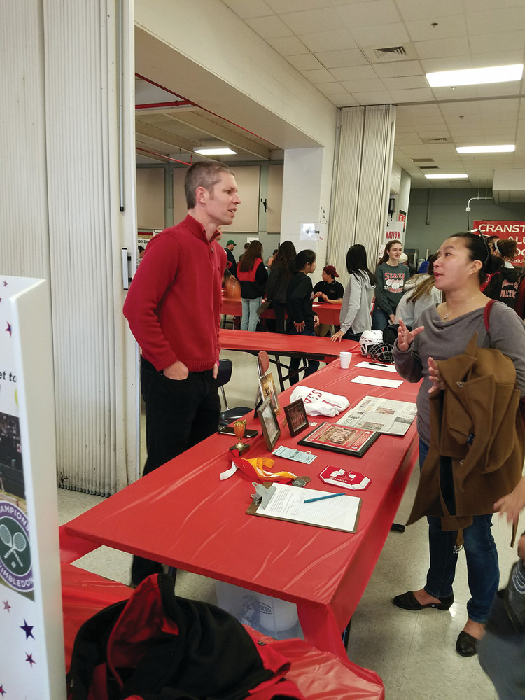 UNIFIED FALCONS: Faculty advisor Matt Reis speaks to a parent at the Unified Falcons table, an extra curricular club open to all students at West, which is an inclusive club encompassing the ideals that the Unified Sports program represents at a whole-school level.