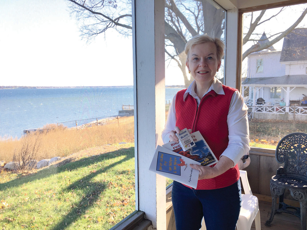 GAME ON: Roberta Mudge Humble shows off both the gorgeous view from the porch of her Warwick home and the Rhode Island themed books and games she&rsquo;s created.