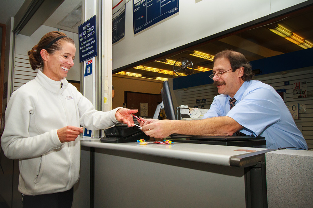 Postal Clerk Tom Vaccaro makes trips to the post office a sweet experience for his customers