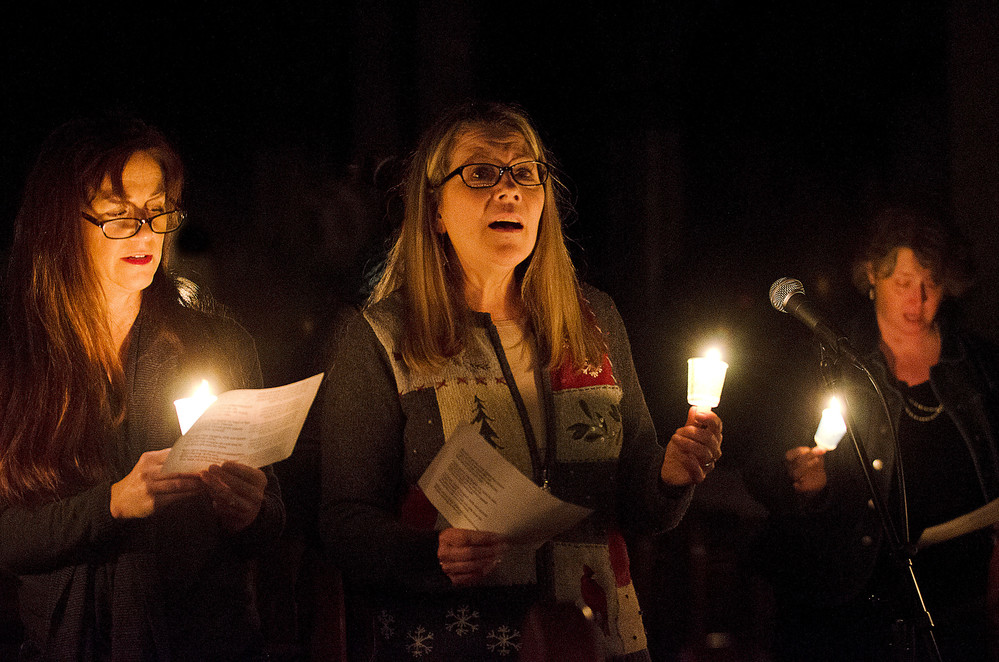 Victoria Boyle leads the group in singing Amazing Grace during a candlelight vigil in memory of Claire Randall at St. Mary's Church on Sunday. More than 100 people gathered Sunday night to remember the tragic loss.