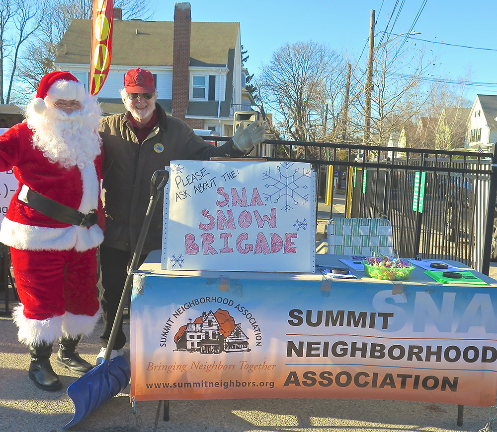 At the Hope Street merchants December 4 opening of holiday festivities, Santa helped Kerry Kohring, SNA vice president, publicize the organization&rsquo;s snow-shoveling program, which pairs volunteers with folks who need assistance. The banner behind them was attached to the food truck that later caught fire.