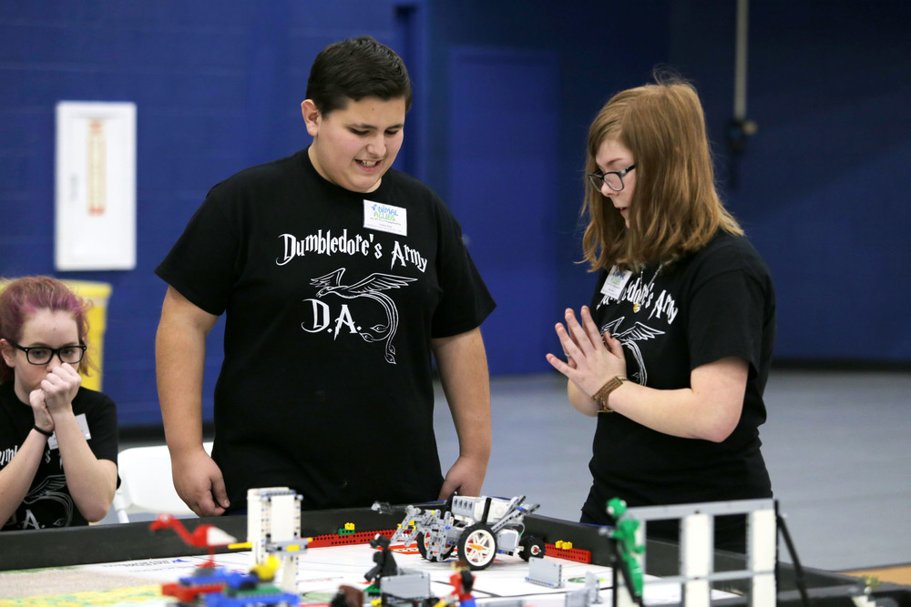 Nate Eisel and Hailie Padula of Riverside Middle School react to their robots performance during the first round of competition in the Lego League Championship.