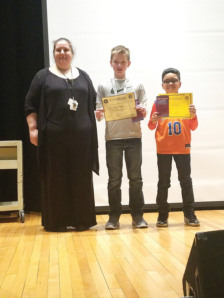 WINNERS: Effie Hantzopoulos poses with the winner, Tyler Moran, and the first runner up, Pablo Cabrera. Both students are sixth-graders and Cabrera was an alternate team representative who was notified just that morning that he would be competing in the afternoon event.