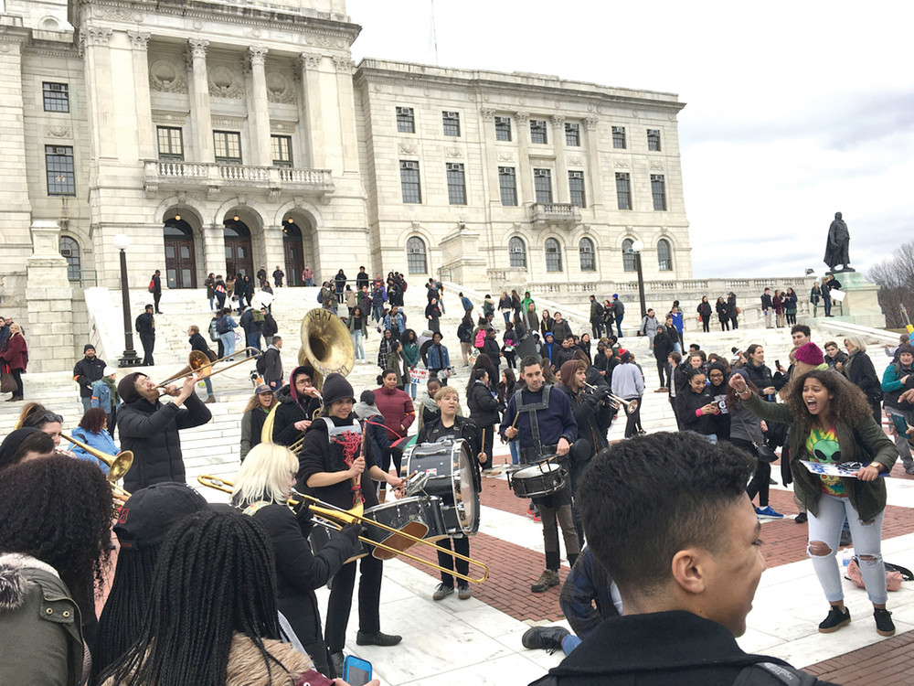 EXPRESSIONS OF HOPE: A band plays and students dance in front of the State House.