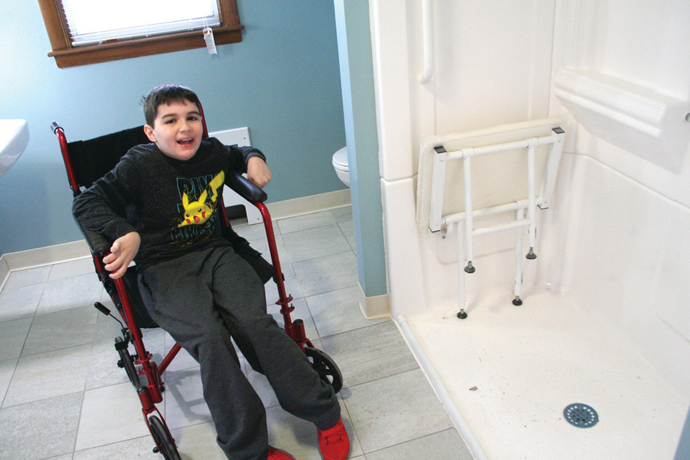 PLENTY OF SPACE: Zach McMillan loves the freedom of his expanded bathroom, a project made possible by the St. Peter Church community and Habitat for Humanity.