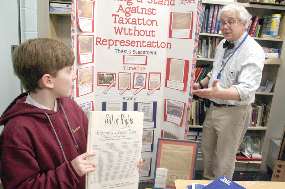 INTO HISTORY: St. Rose of Lima 7th grader Aidan Toussaint with teacher Steve Andolfo and his History Day project on the U.S. Constitution.