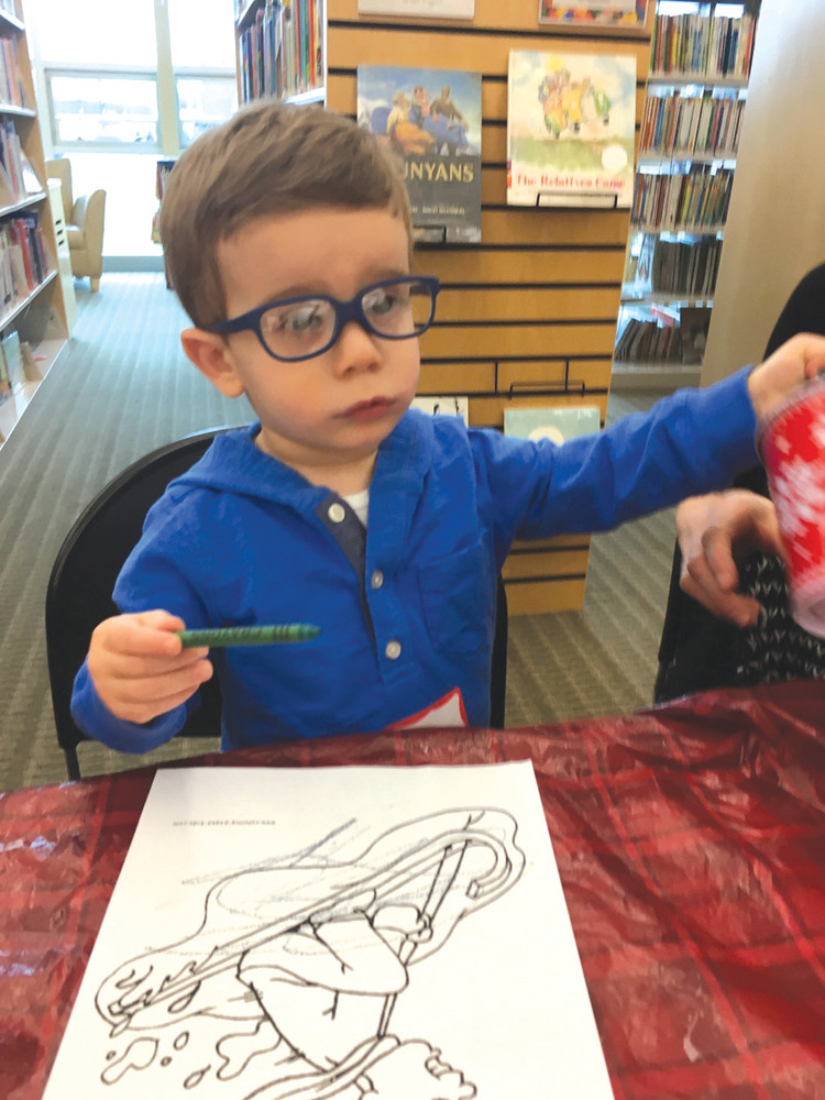 CRAFTING A READER: Joey Zinni Jr., 22 months old, enjoys coloring during story-time at the Mohr Library.  For a complete list of upcoming programs at the library, see the Sun Rise Scoops column in today's paper.