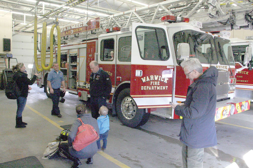 CENTER OF ATTENTION: Ladder 4 was popular during the open house with children and their parents getting to sit behind the wheel or look out the window, as Abby Morse does here.