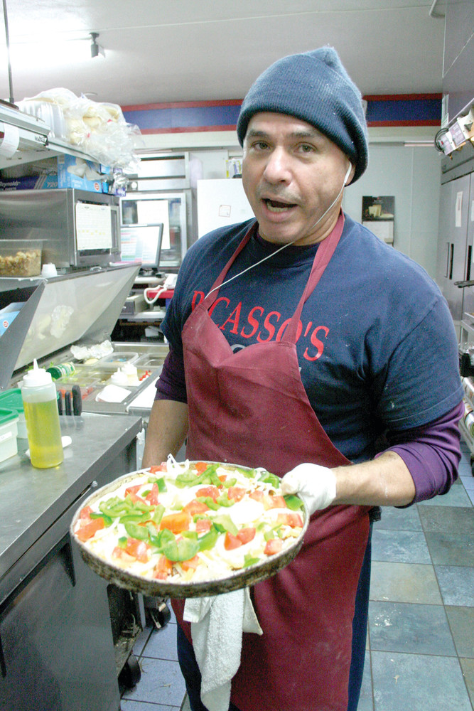 HE&rsquo;LL BE THERE: Herm Ponte, who has been with Picasso&rsquo;s Pizza and Pub for 20 years, anticipates he&rsquo;ll make about 200 pizzas for Super Bowl crowds. Here, Herm prepares an &ldquo;illegitimate&rdquo; Mexican pizza for the oven. &ldquo;There&rsquo;s no hot peppers on this one,&rdquo; he said.