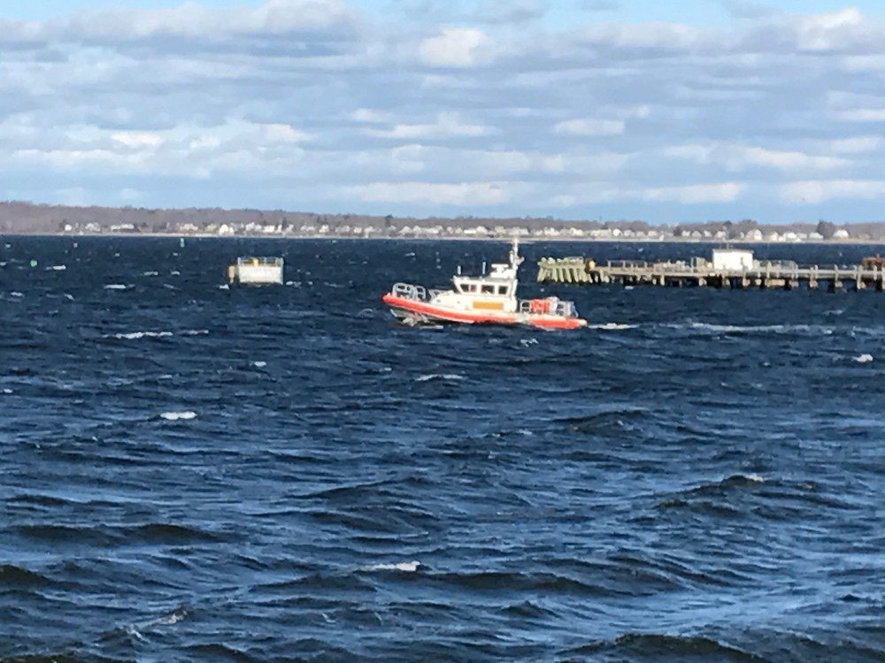 A Coast Guard boat searches waters near the fuel docks in north Tiverton just before 9 a.m. Thursday.
