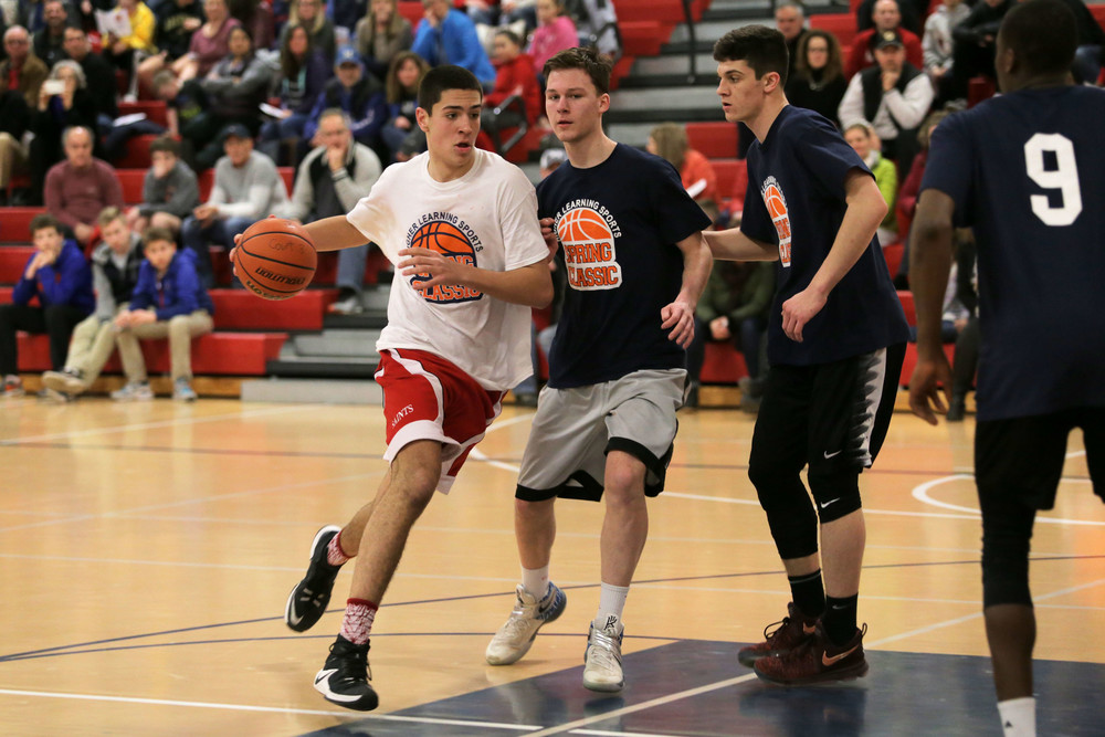 Cole Swider of Portsmouth, a junior at St. Andrew&rsquo;s School, pushes past opponents as he drives toward the net during the second annual Higher Learning Sports Spring Classic Wednesday. He was the high-scorer for the night, with 45 points.