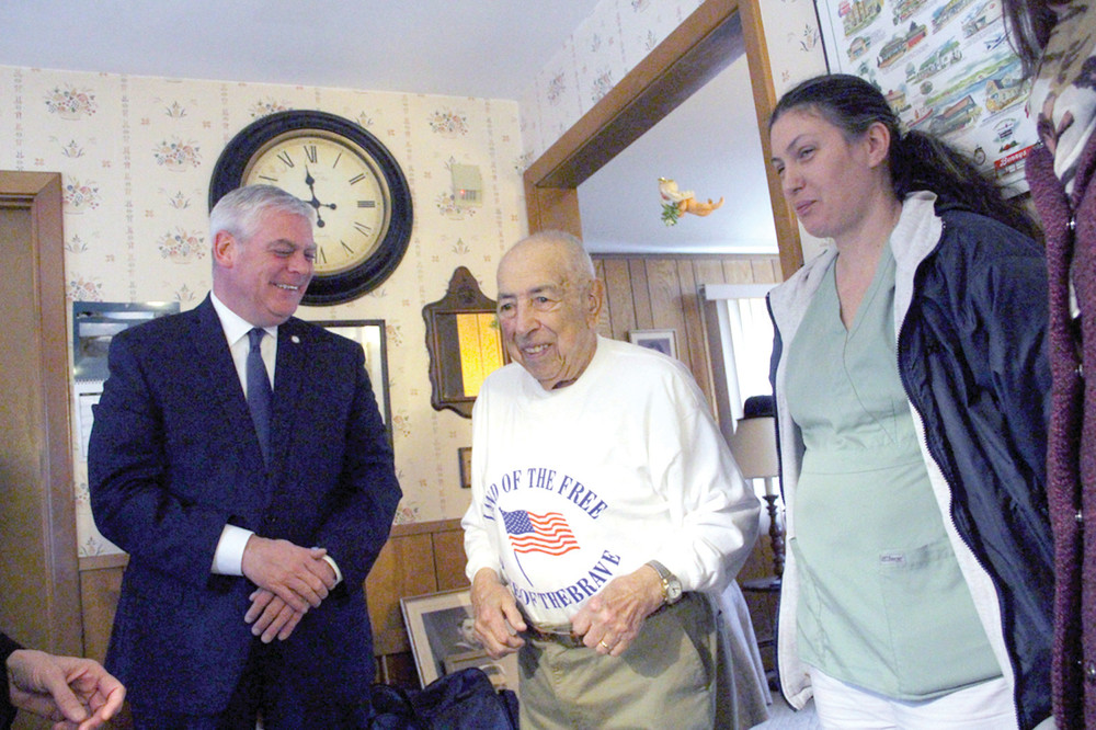SHARING A STORY: Franks Amalfetano kept Mayor Scott Avedisian laughing and his care giver Juliette Piette smiling with his stories Tuesday when the mayor delivered his Meals on Wheels dinner.