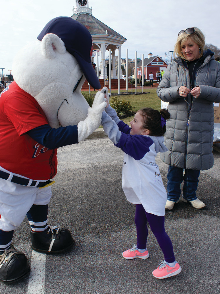 HIGH FIVES: Ava Furtado, 4, high fives the PawSox mascot, Paws. Ava&rsquo;s sister, Celia, is a Tomorrow Fund child.