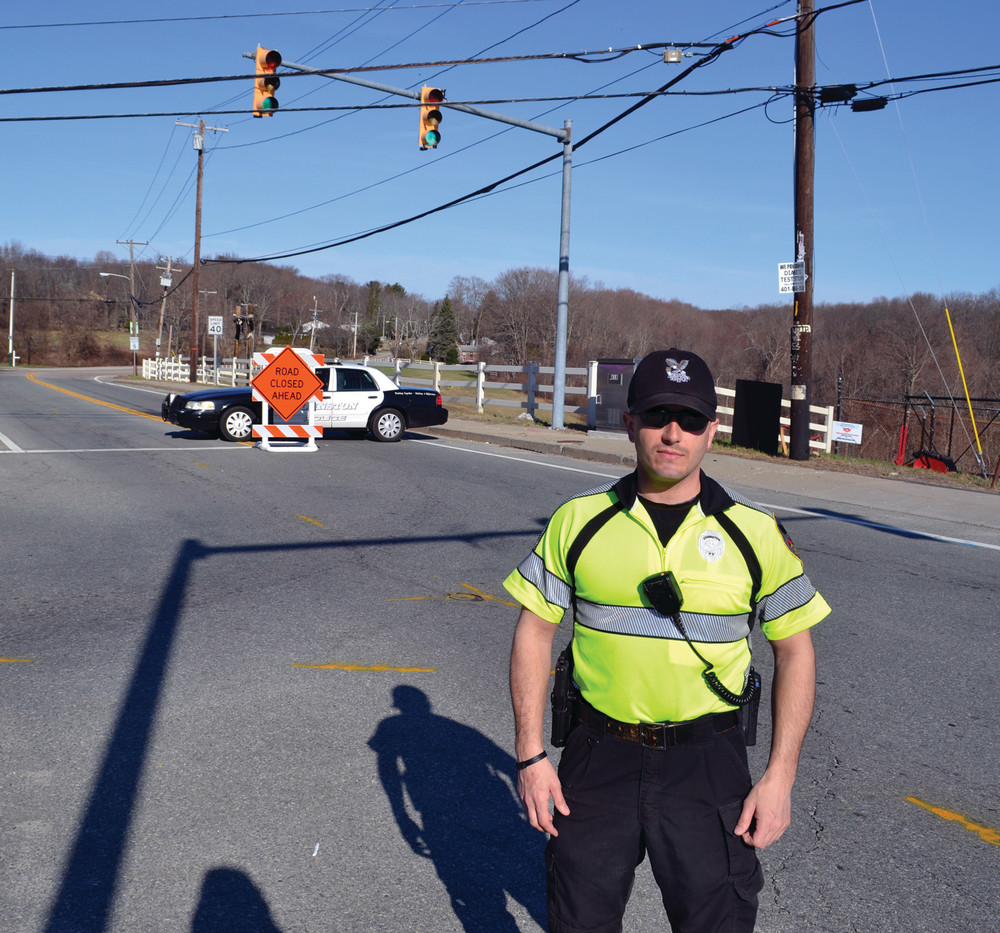 ROAD CLOSED: Officer Arthur Petteruti was on the scene directing traffic at the intersection of Greenville and Atwood avenues Monday morning when the construction project began. He said while there were a few irate drivers, most operators were taking the detours in stride.