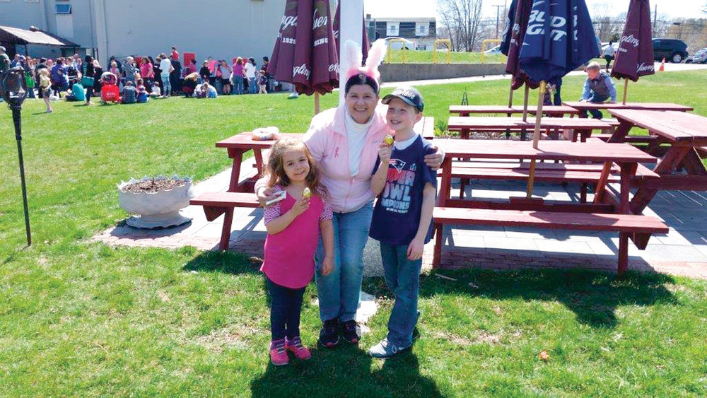 Lauren (left) and Anthony get a congratulatory hug from Marie Cavanaugh, the Youth Committee Chairperson, after finding the Golden Egg in the first-ever Tri-City Elks Lodge Easter Egg Hunt.