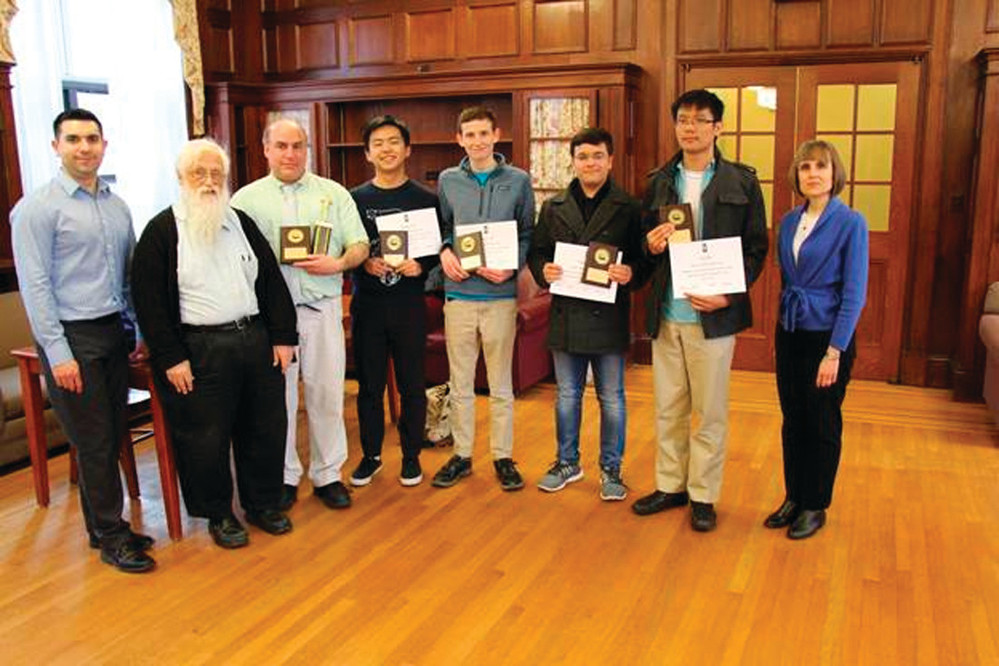 WINNING PROGRAMMERS: The Hendricken team won the 31 annual computer programming competition held at Providence College. Pictured from left are: Dr. Adam Villa, associate professor of computer science at Providence College; Francis Ford, assistant professor of computer science of Providence College; Mark DiPippo, coach; Yuanbo Jiang, junior student; Henry Pratt, senior student; Paarth Tandon, sophomore student; Fred Choi, senior student; Dr. Sheila Liotta, dean of the school of arts and sciences at Providence College.