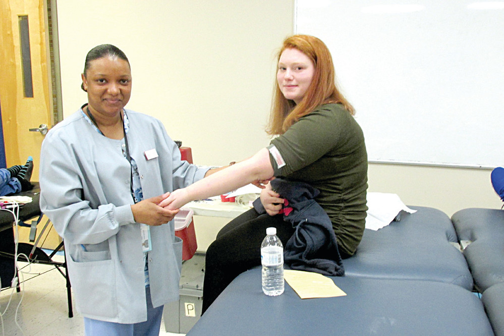 GIFT GIVER: Anna Lake of the Rhode Island Blood Center prepares Johnston High student Faith Proulx, who was one of more than 65 Panthers who gave blood during January&rsquo;s drive.