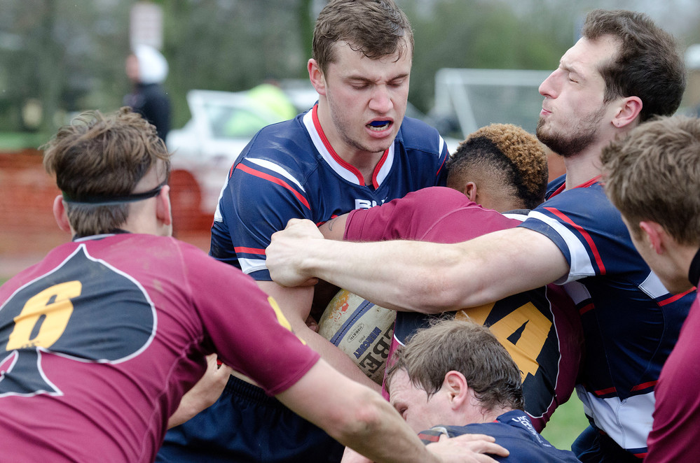 UConn rugby players from top left, Joe Phillips, Jacques Prevost and Ethan Opsahl (below) combine on a tackle during their match against Salisbury on Saturday.