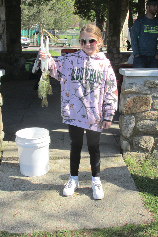 GOT TO CATCH THEM ALL: Camryn Phillips proudly displays her catch of the day. Phillips ended up receiving second place for most fish caught at the derby on Sunday.