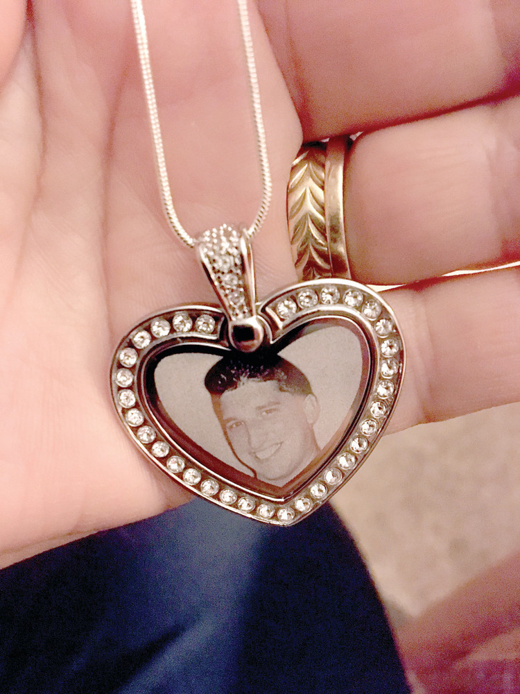 LOCKET OF LOVE: Diane Lang holds a locket with her son Brian&rsquo;s photo inside.