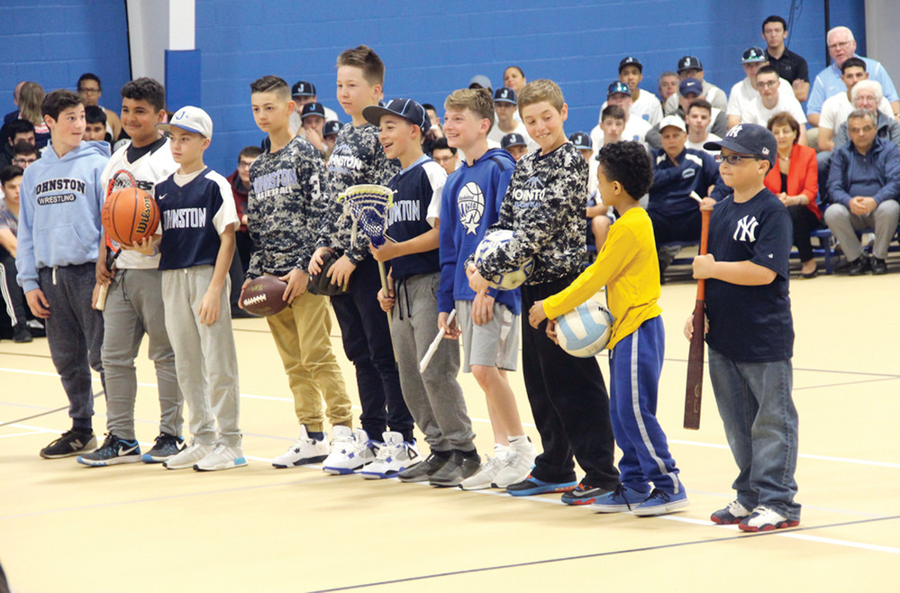 Members of Johnston youth sports teams take part in the ceremonies.