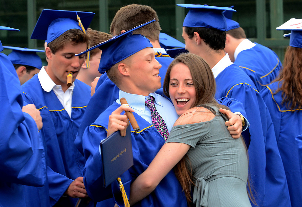 Tommy Murray gets a hug from girlfriend, Kayla Howarth in the courtyard after graduation.