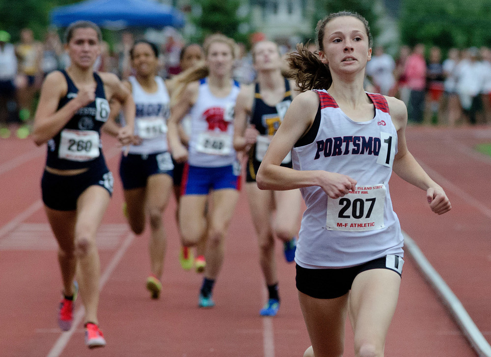 Portsmouth&rsquo;s standout sophomore, Nikki Merrill, had another big day, winning both Three gold medals for the 1,500 and 800 meters and running a leg on the victorious 4x800 relay.  Here she leads the pack during the 1500.