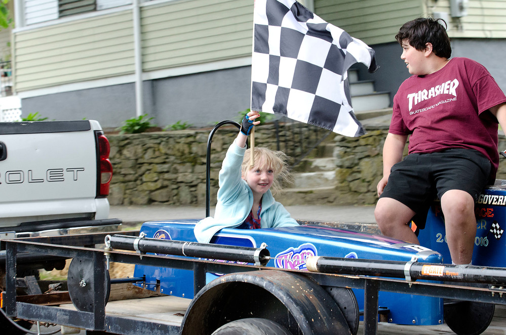 Kara Pisasale is towed up Bay View Avenue for a victory tour after winning the 68th annual Orange Crate Derby.