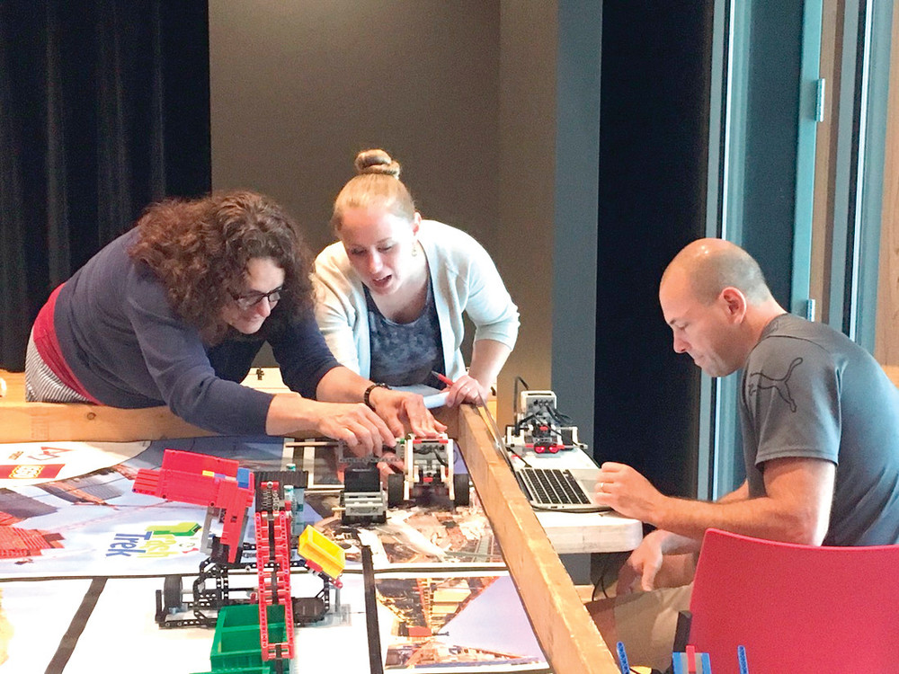 LEARNING BRICK BY BRICK: Teachers Sophia Michalopoulos, Rachael Franklin and Dan Villard collaborate on a robotics challenge during the 2016 LEGO Robotics course offered by Rhode Island Students of the Future. The organization is offering a professional development course July 31 to August 2 for teachers, librarians, after school providers and parents. For more information, visit www.risf.net.