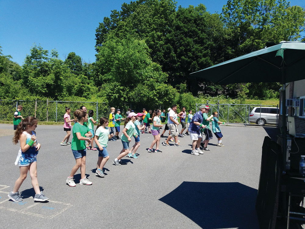 PUMP UP THE JAMS: A dance party took place on the blacktop outdoors, showing students that physical fitness can be fun.
