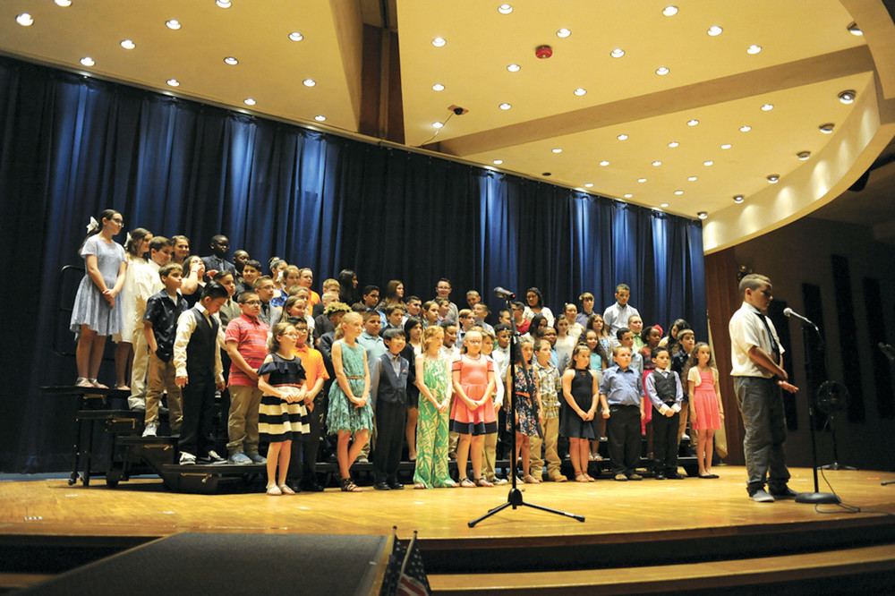 PICTURE PERFECT: The entire fifth grade class of Winsor Hill stands behind Raymond Cimino as he announces a dance routine.