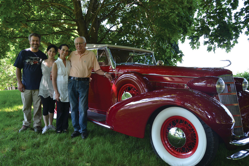 COMPLETED CAR: John Ricci is joined by his wife Donna, daughter Jennifer and son John Michael as he shows off his recently completed 1934 Cadillac.
