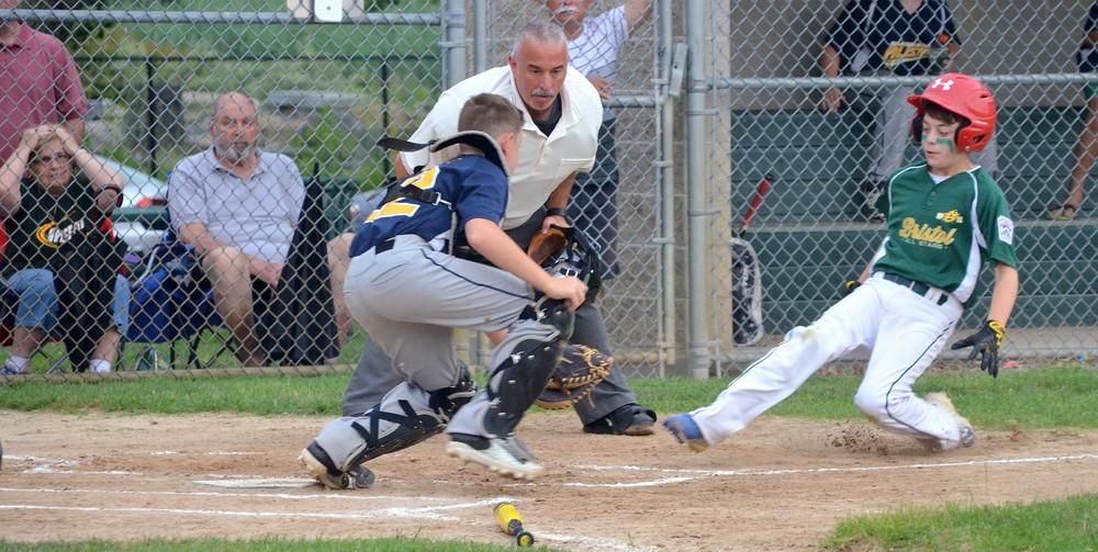 Barrington catcher Andrew La Pointe gets set to put the tag on Bristol baserunner at home plate.