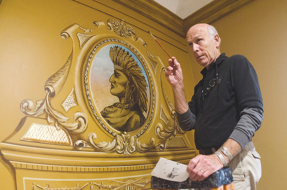 Johan Bjurman works on the recreation of a painting at the Historic Warren Armory.