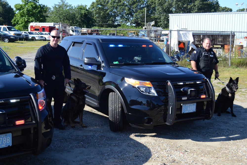 K-9 officers Aaron Steere and Paul Wells with their K-9 partners, Viking and Fox.