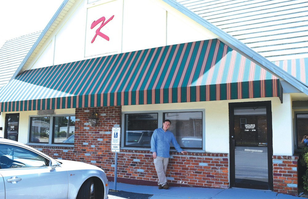 BACK IN BUSINESS: Above, Kenny DeMarco, Jr., leans outside of his establishment, Kenny&rsquo;s Place, which now sports a &lsquo;K&rsquo; on the side of the building.