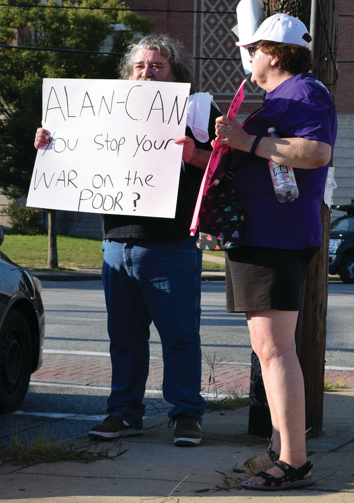 A POSTER FOR NEARLY EVERYONE: Almost every protester had some form of poster, including George Hanley.