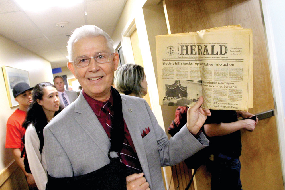 SAME STORY, DIFFERENT DAY: Rep. Robert Lancia holds a copy of Cranston Herald from the late 1970s with a lead page article about electric rate increases. &ldquo;Things never change&rdquo; was his message.